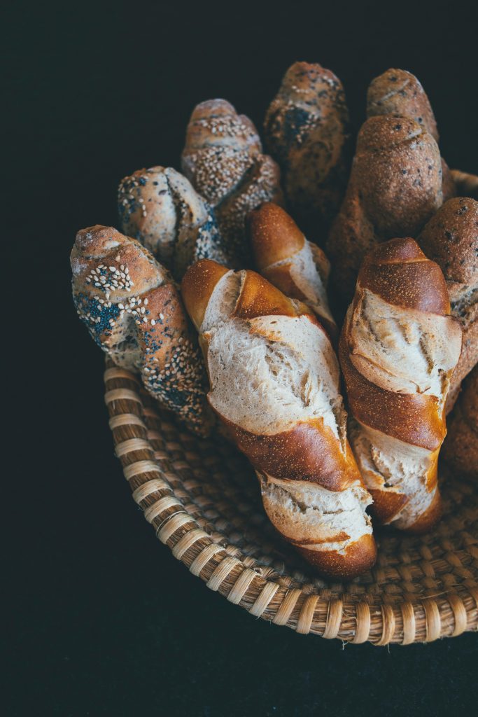 pexels-photo-1871024-1871024 A top view of a basket filled with various freshly baked baguettes, perfect for food photography enthusiasts.